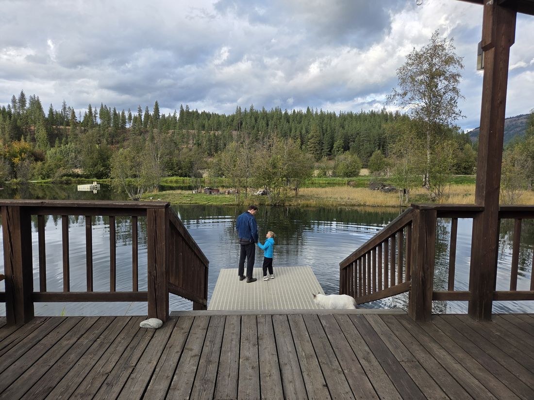 Two people on the dock at the pond