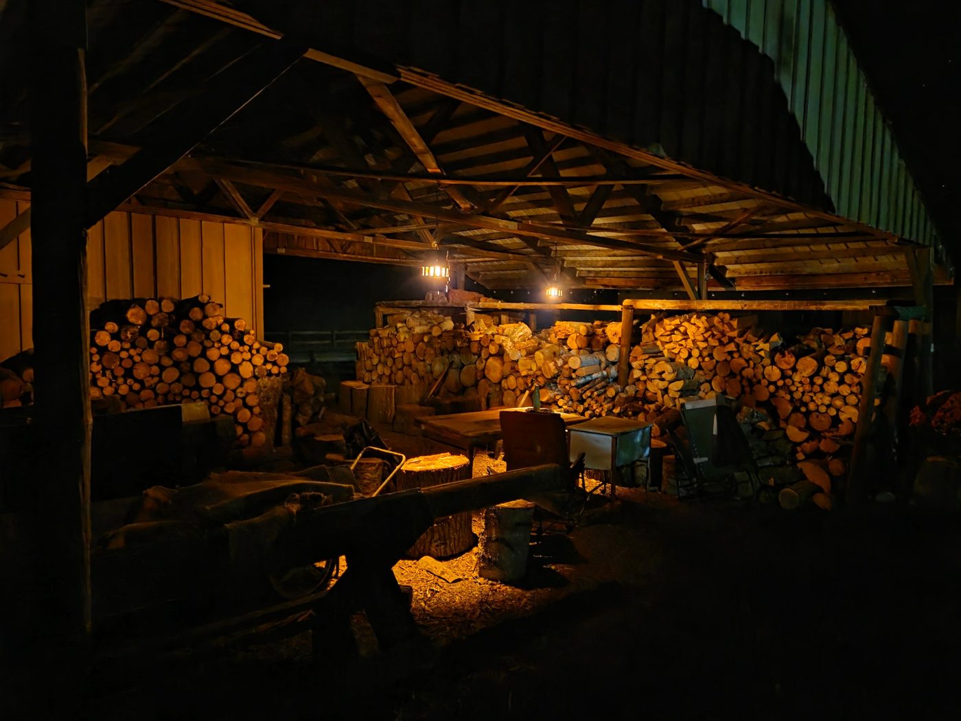 The woodshed lit by two lanterns at night