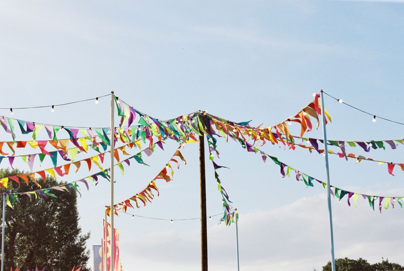 Rows of colorful tent flags strung against the sky at the fest grounds